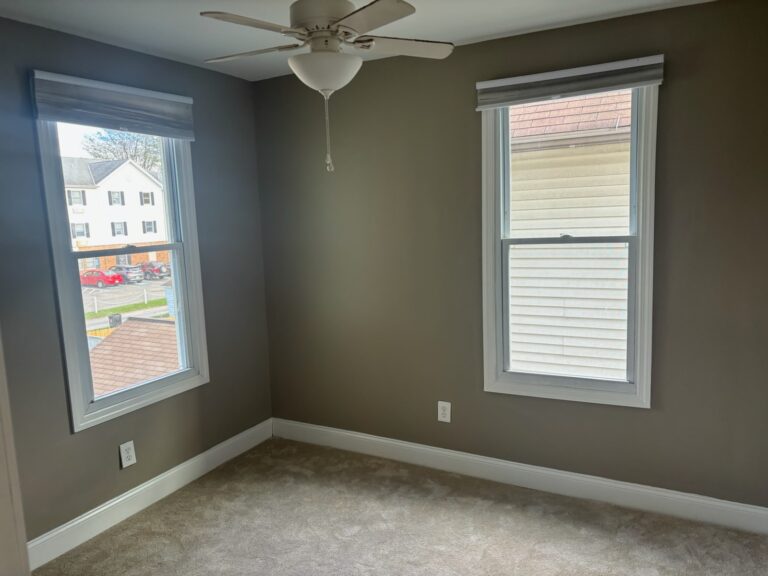 Bedroom with two windows painted in a warm grey