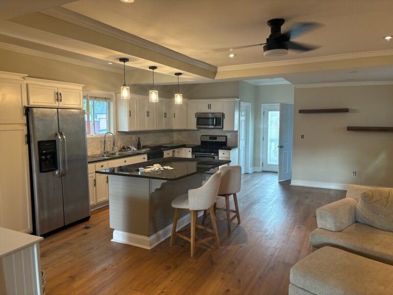 Kitchen with freshly painted white cabinets and pendant lighting